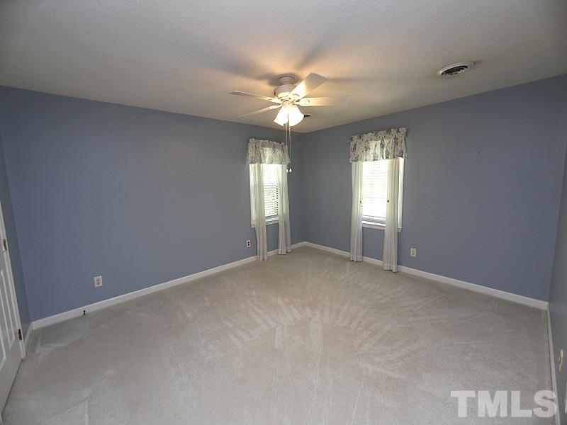 312 Baytree Lane Raleigh, NC 27615 - Photo 9 of 12 a view of an empty room with window and chandelier fan