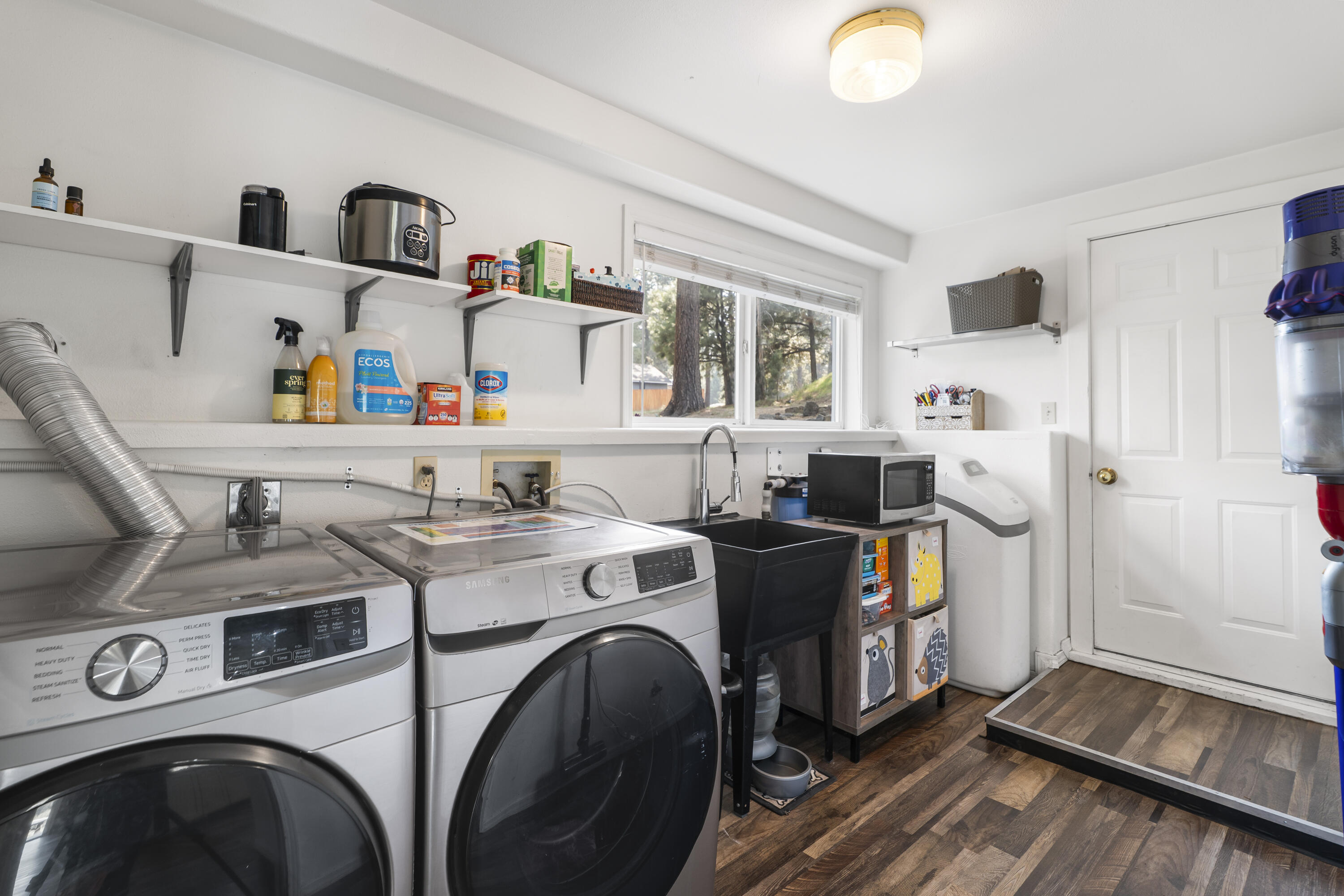 17062 Milky Way Bend, OR 97707 - Photo 33 of 39 Spacious laundry room with utility sink, lots of storage and garage access