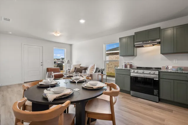 a kitchen with a stove and white cabinets