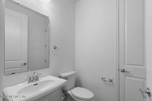 a bathroom with a sink toilet and vanity