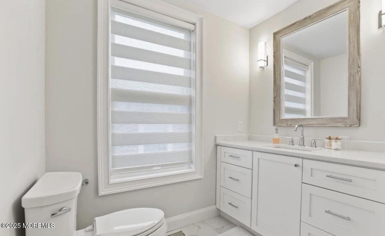 7 Center Street Sea Bright, NJ 07760 - Photo 9 of 19 a bathroom with a toilet sink and mirror