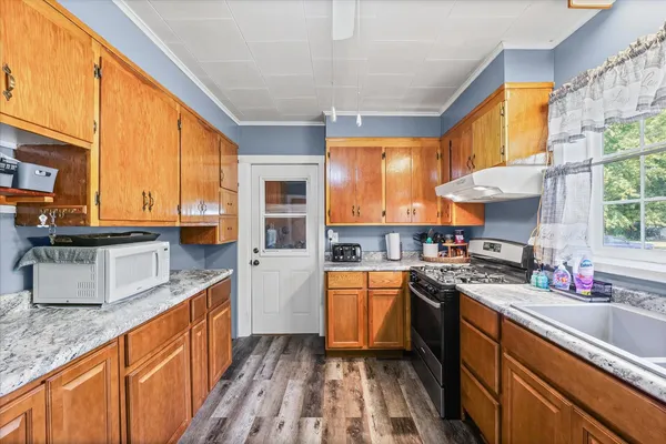 a kitchen with stainless steel appliances granite countertop sink stove and cabinets