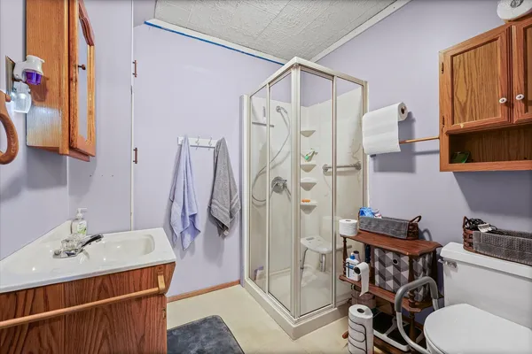 a bathroom with a sink toilet and shower