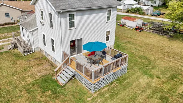 a view of a house with pool and a yard
