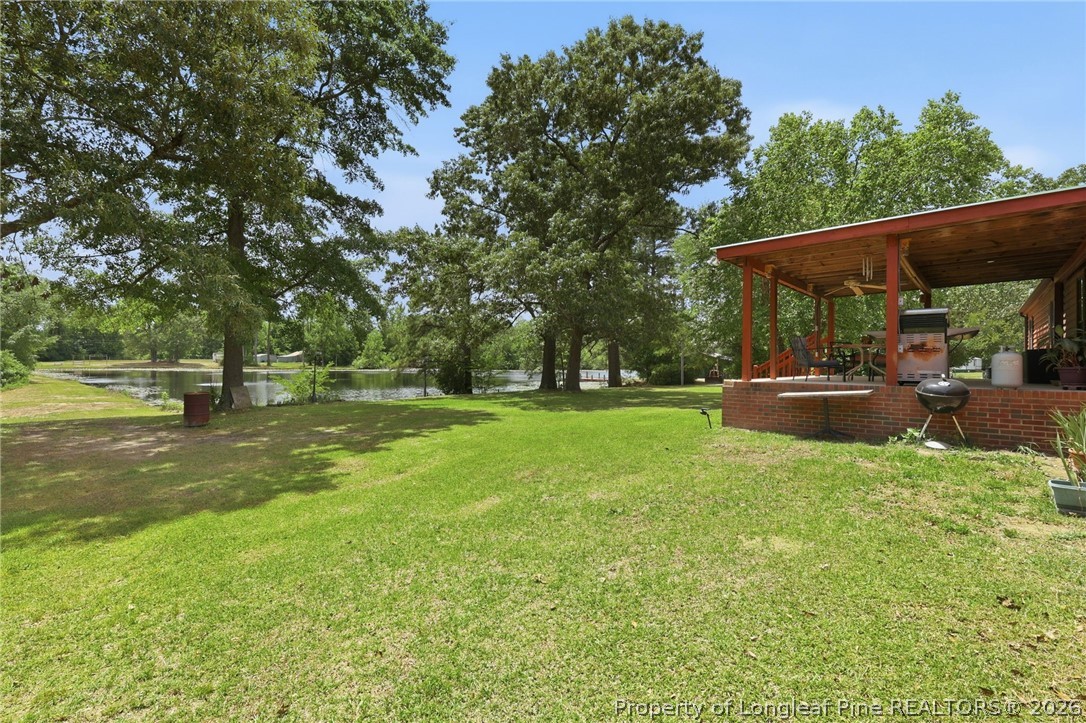 10400 Ruth Vinson Road Autryville, NC 28318 - Photo 17 of 49 a view of outdoor space with deck and garden