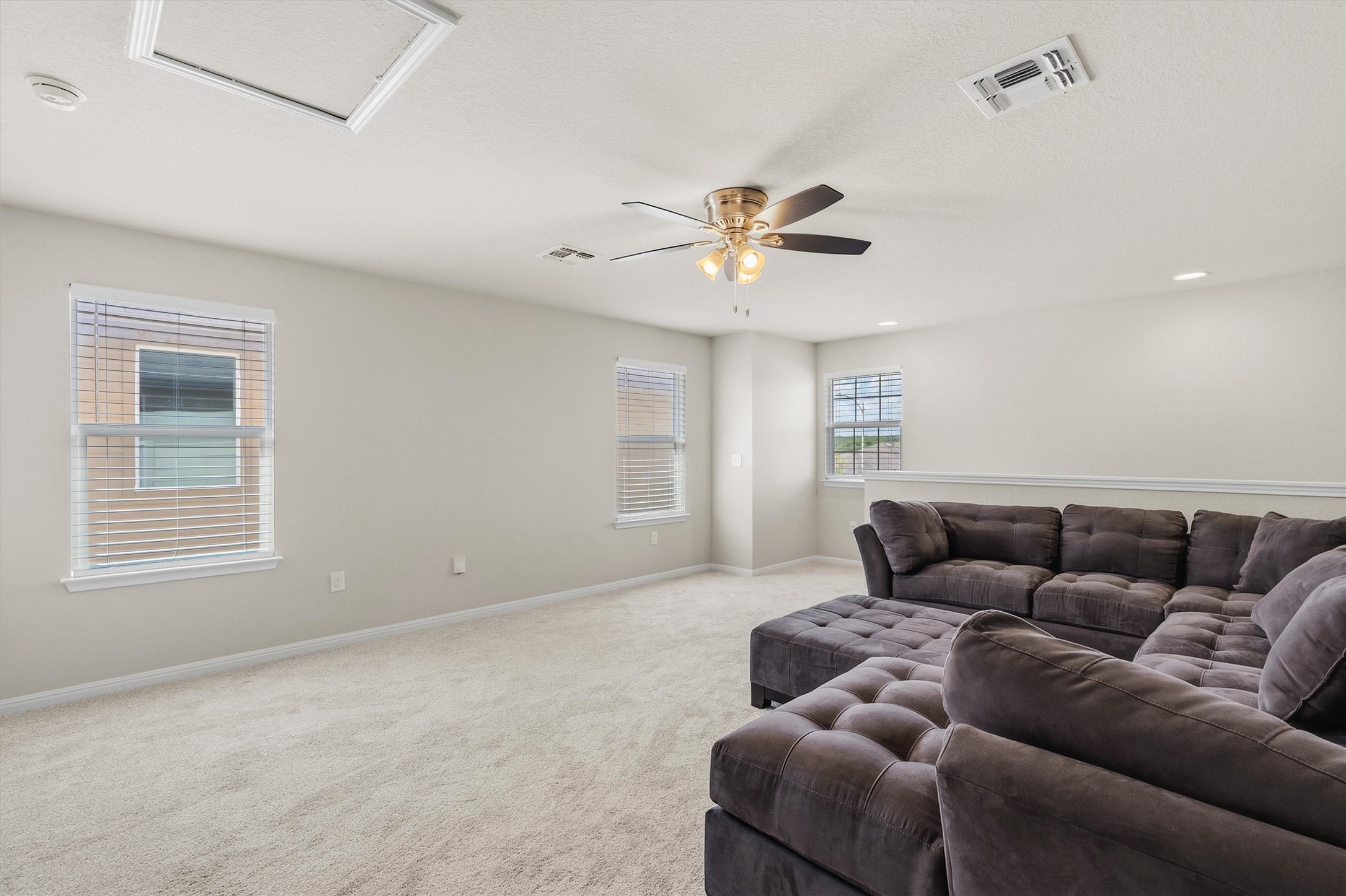 10817 Gonzales Ranger Pass Austin, TX 78754 - Photo 26 of 37 This room is surrounded by windows, flooding the entire upper level with natural sunlight. There is so much extra square footage here, you could easily tuck a homework station or reading nook into the corner!