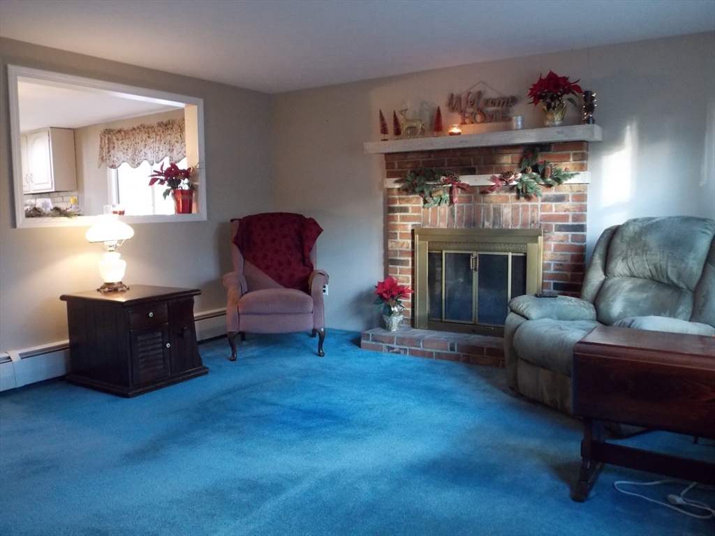 78 2nd Island Road Webster, MA 01570 - Photo 11 of 28 a living room with furniture and a fireplace
