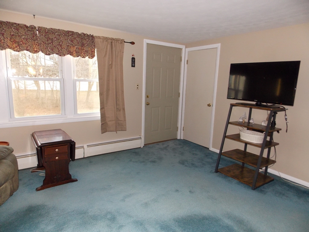 78 2nd Island Road Webster, MA 01570 - Photo 12 of 28 a living room with furniture and a flat screen tv