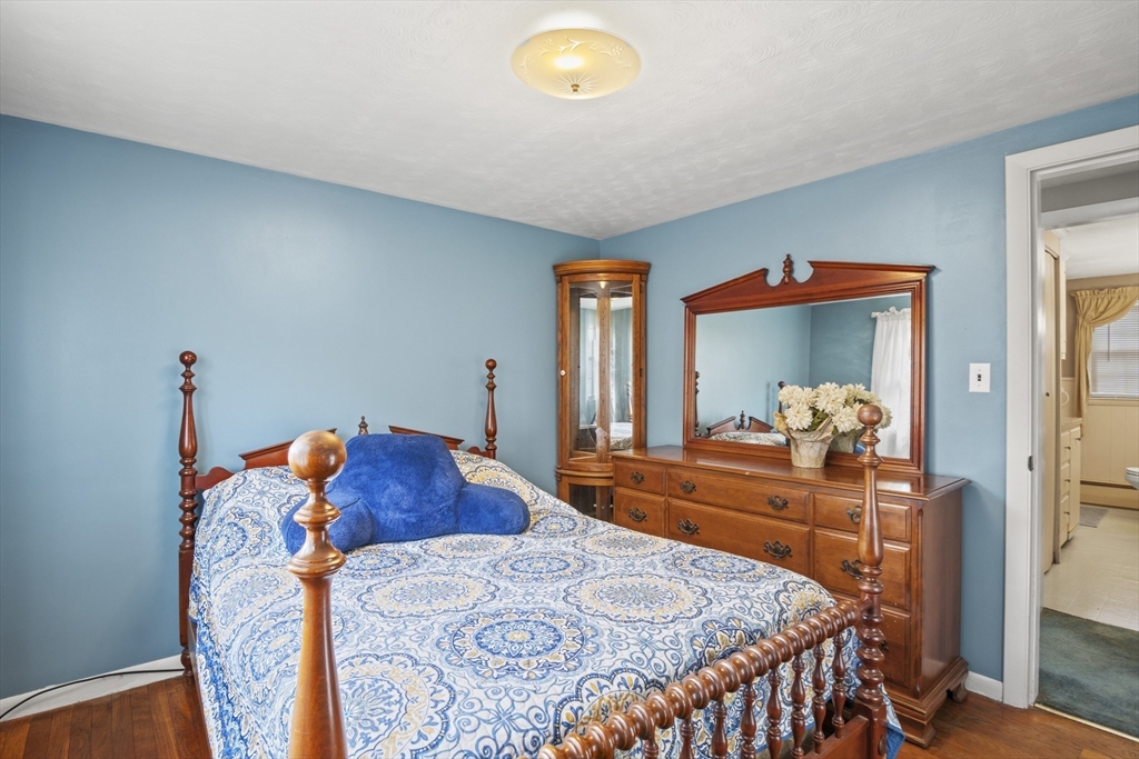 78 2nd Island Road Webster, MA 01570 - Photo 19 of 28 a bedroom with a bed and a chandelier