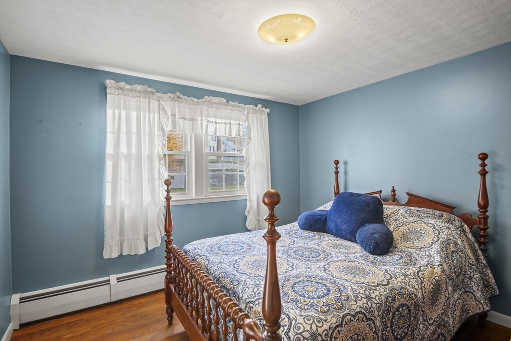 78 2nd Island Road Webster, MA 01570 - Photo 20 of 28 a bedroom with a bed and wooden floor