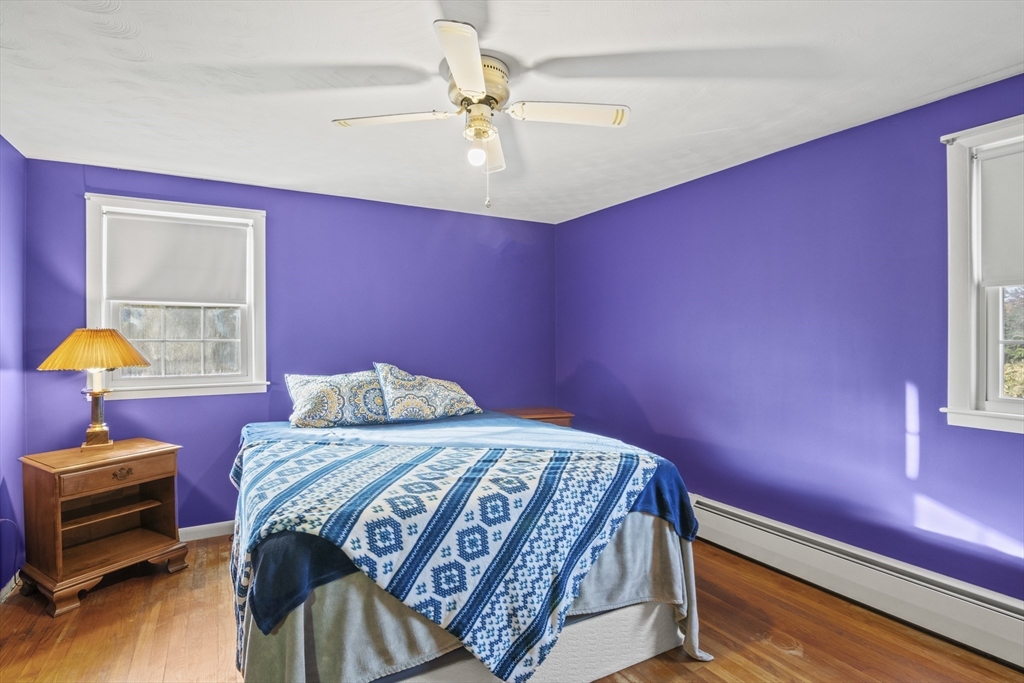 78 2nd Island Road Webster, MA 01570 - Photo 21 of 29 a bedroom with a bed and a chandelier