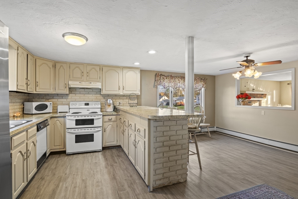 78 2nd Island Road Webster, MA 01570 - Photo 5 of 28 a kitchen with stainless steel appliances granite countertop a stove top oven a sink dishwasher and a refrigerator with wooden floor