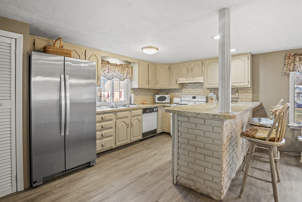 78 2nd Island Road Webster, MA 01570 - Photo 8 of 29 a kitchen with stainless steel appliances a refrigerator sink and cabinets