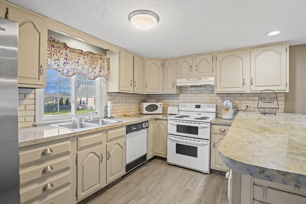 78 2nd Island Road Webster, MA 01570 - Photo 10 of 29 a kitchen with stainless steel appliances granite countertop a stove a sink and white cabinets