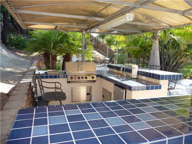4603 Sheridan Road Oceanside, CA 92056 - Photo 3 of 25 Outdoor Kitchen which includes gas BBQ, additional burner, fridge, sink, and draws and cabinet space. Custom made cover. This yard features over $10,000 in custom outdoor lighting.