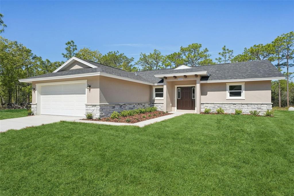 a front view of house with yard and green space