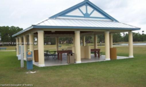 6503 Colma Avenue Sebring, FL 33872 - Photo 13 of 28 a view of a house with floor to ceiling windows and a lawn chair