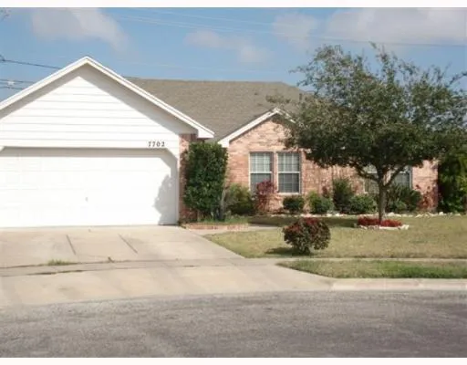 a view of a house with a yard and garage