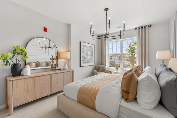 a bedroom with a bed and a chandelier