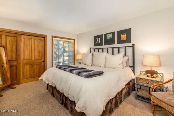 a bedroom with a bed and a lamp on table