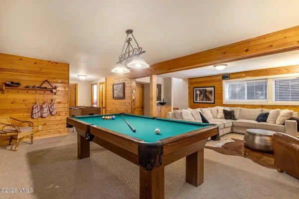 a room with pool table and windows