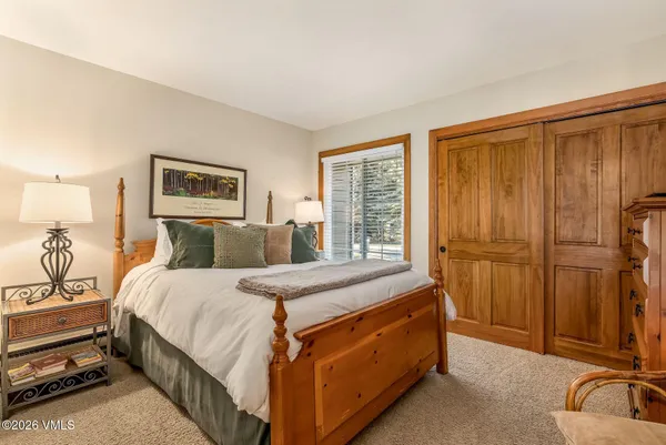a bed room with a bed and a night stand