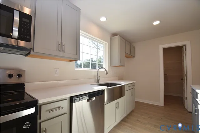 a kitchen that has a sink and a stove in it