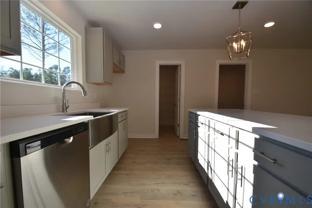 a kitchen with granite countertop a sink and a stove
