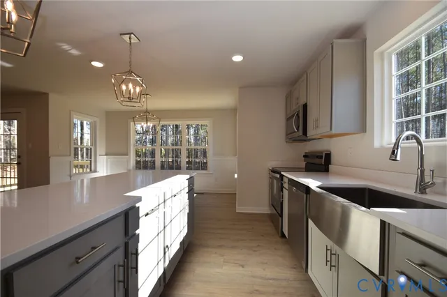 a large white kitchen with a large window