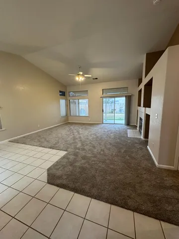 a view of empty room with window and fireplace