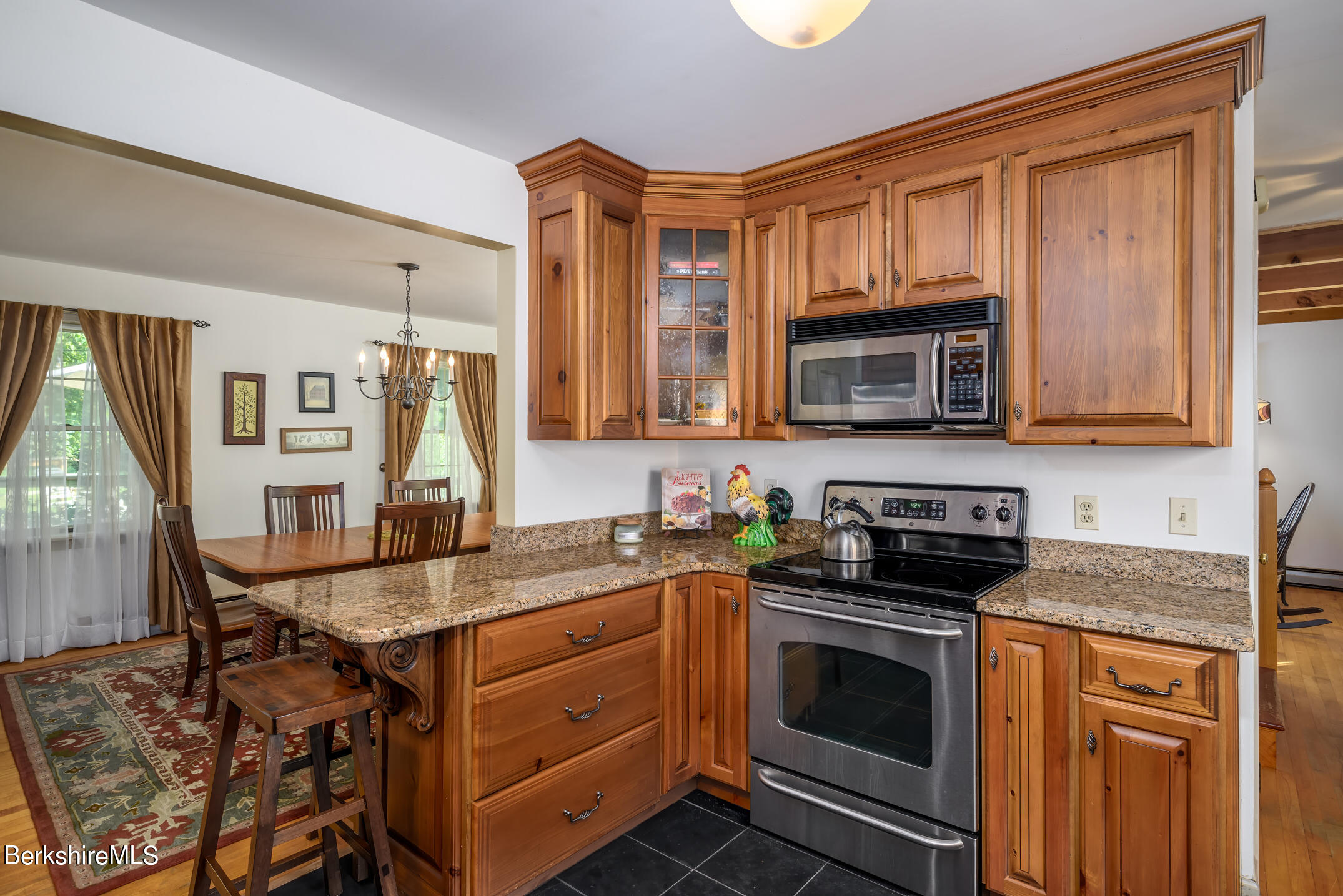 69 County Road Pownal, VT 05261 - Photo 14 of 33 a kitchen with stainless steel appliances granite countertop a stove microwave and cabinets