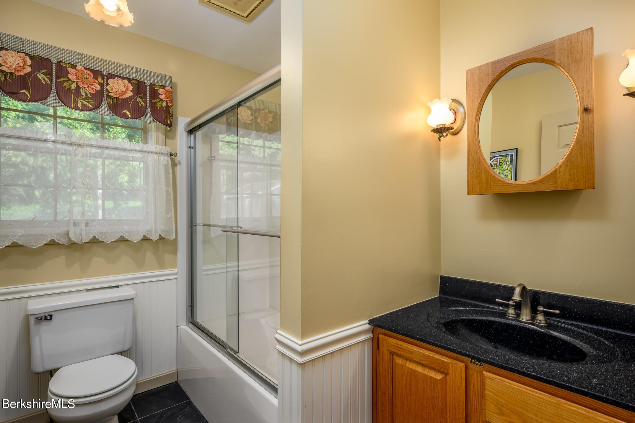 69 County Road Pownal, VT 05261 - Photo 18 of 33 a bathroom with a granite countertop toilet sink and mirror