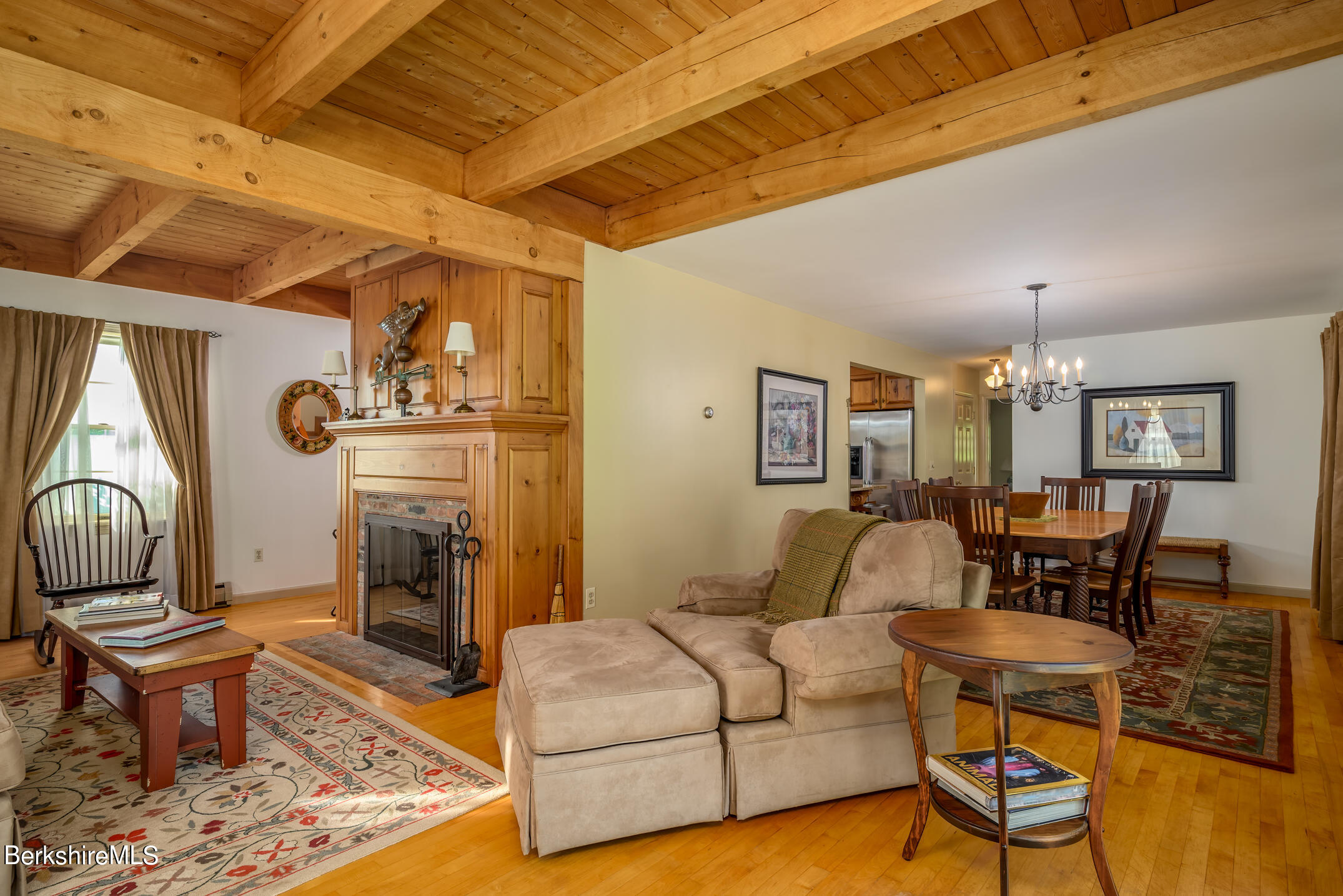 69 County Road Pownal, VT 05261 - Photo 22 of 33 a living room with furniture a fireplace and a dining table with wooden floor