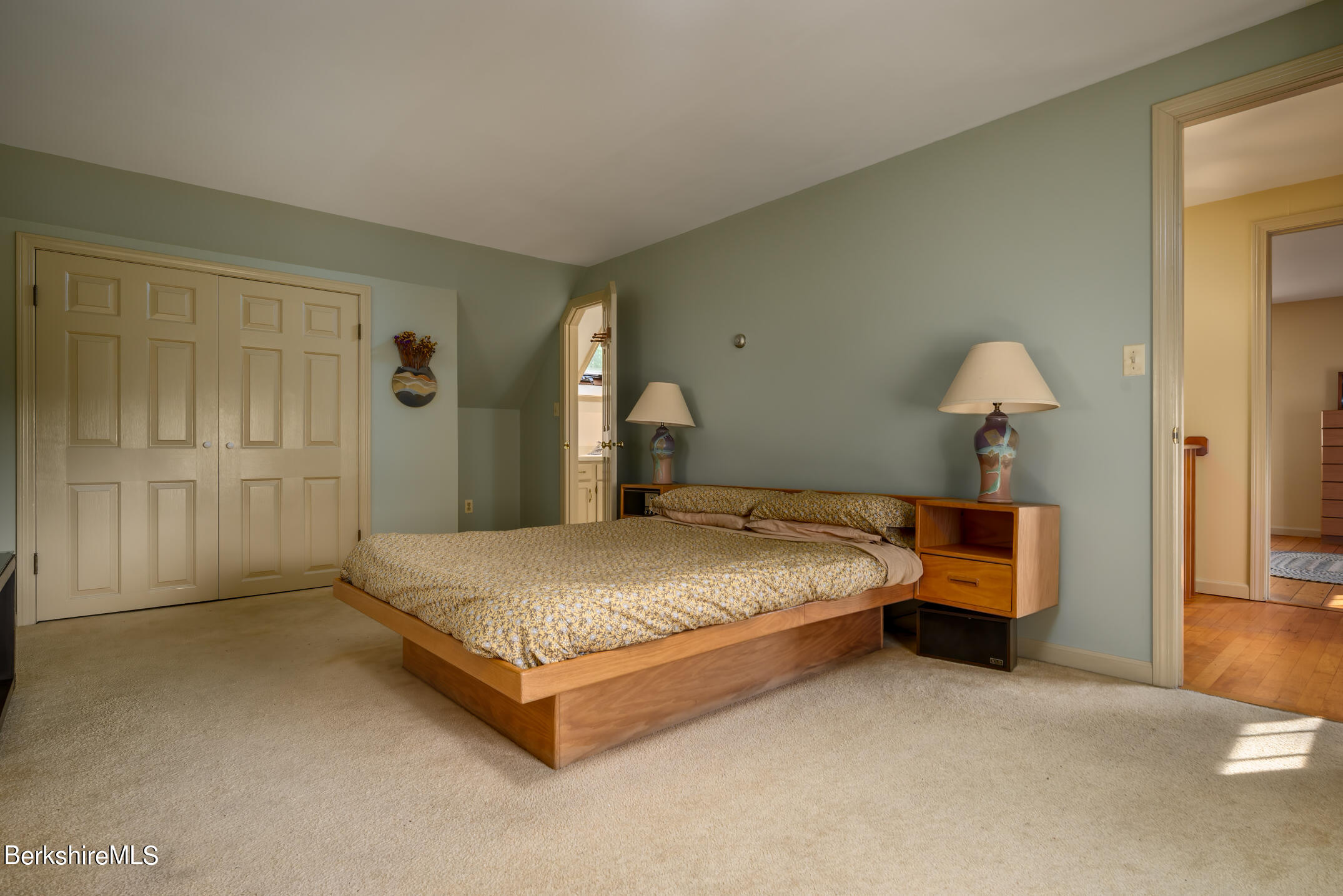 69 County Road Pownal, VT 05261 - Photo 27 of 33 a spacious bedroom with a bed and a table