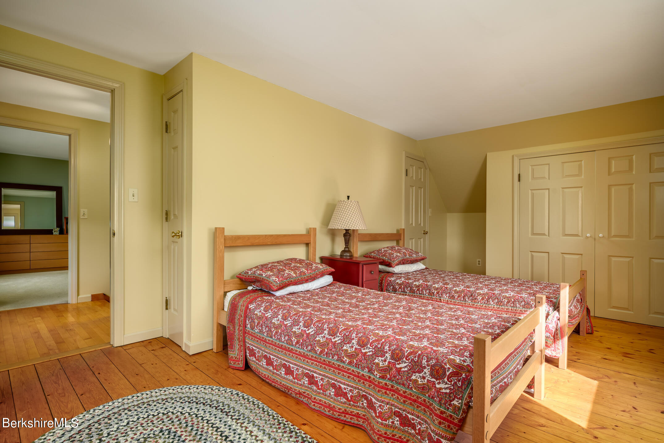 69 County Road Pownal, VT 05261 - Photo 30 of 33 a bedroom with a bed and wooden floor