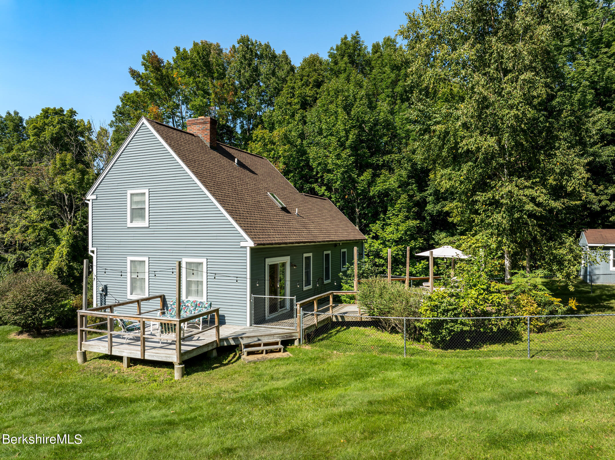 69 County Road Pownal, VT 05261 - Photo 6 of 33 a front view of a house with a garden and trees