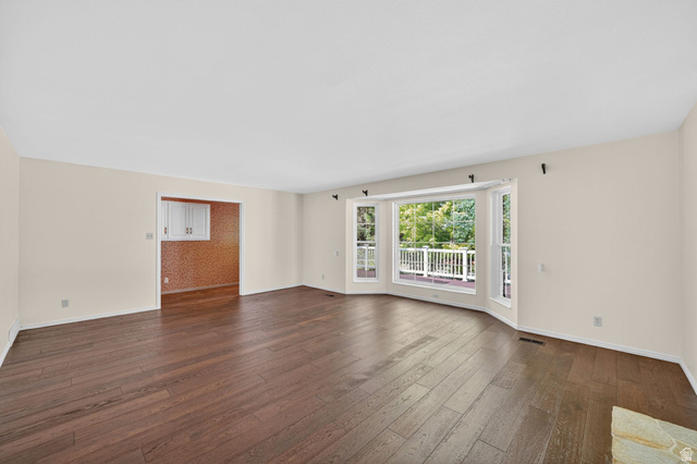 3120 North Apache Way Provo, UT 84604 - Photo 20 of 58 Expansive living area featuring rich wood-finish flooring and neutral wall tones