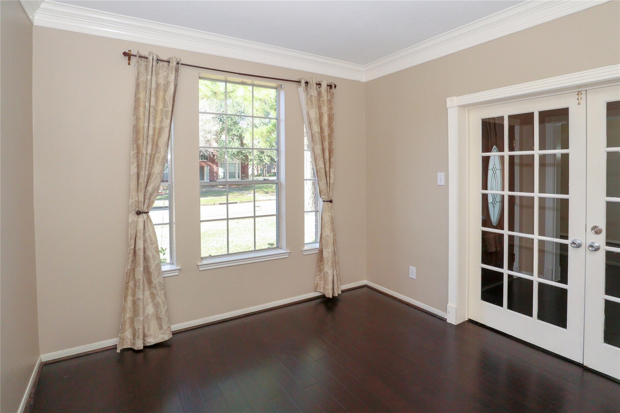 23207 Olive Ridge Court Katy, TX 77494 - Photo 13 of 45 an empty room with wooden floor and windows