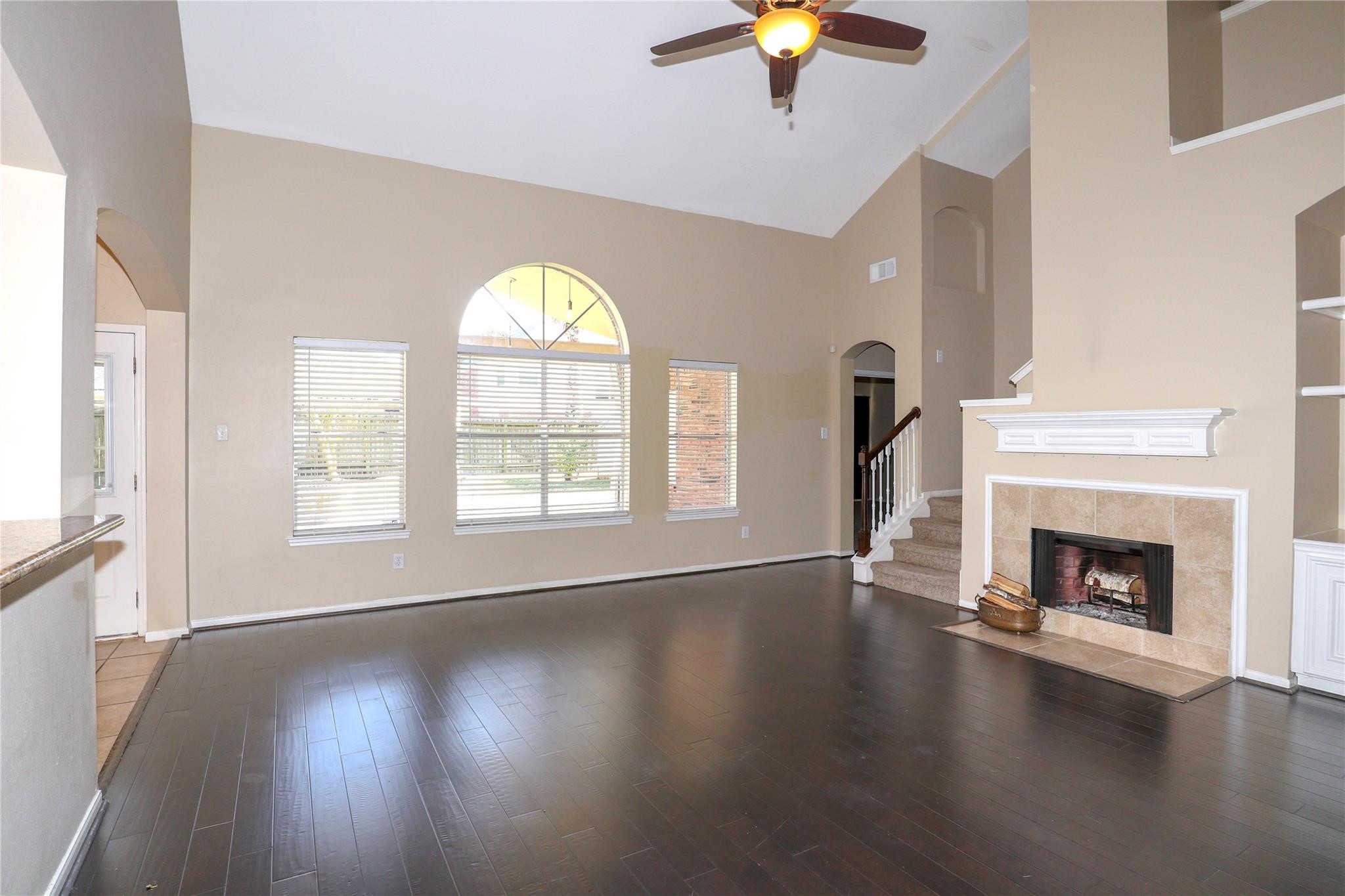 23207 Olive Ridge Court Katy, TX 77494 - Photo 16 of 45 a view of an empty room with wooden floor fireplace and a window
