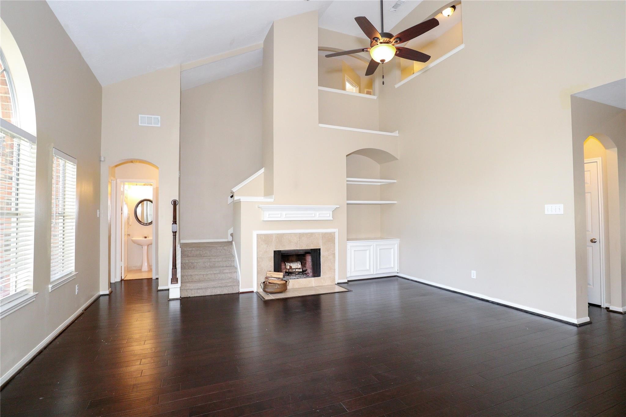 23207 Olive Ridge Court Katy, TX 77494 - Photo 17 of 45 an empty room with windows and fireplace