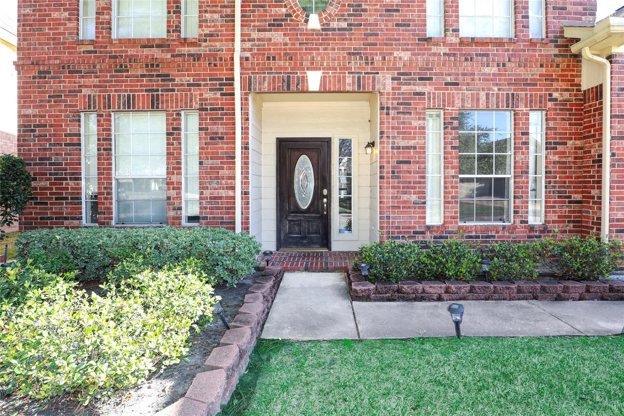 23207 Olive Ridge Court Katy, TX 77494 - Photo 2 of 45 a front view of a house with a yard and outdoor seating
