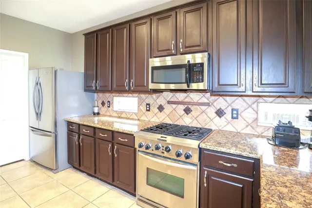 a kitchen with a sink and a mirror