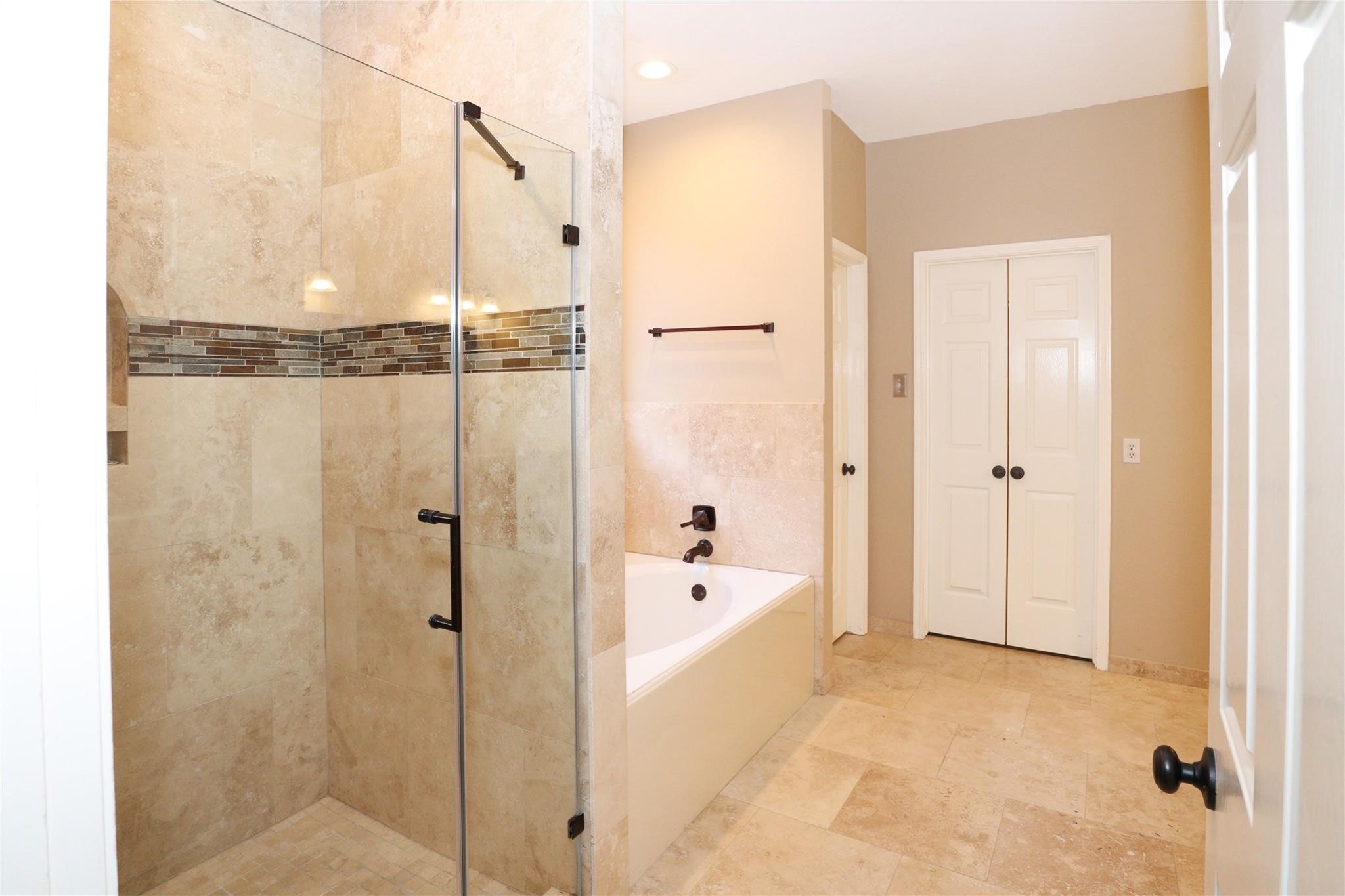 23207 Olive Ridge Court Katy, TX 77494 - Photo 29 of 45 a bathroom with a bathtub and a shower