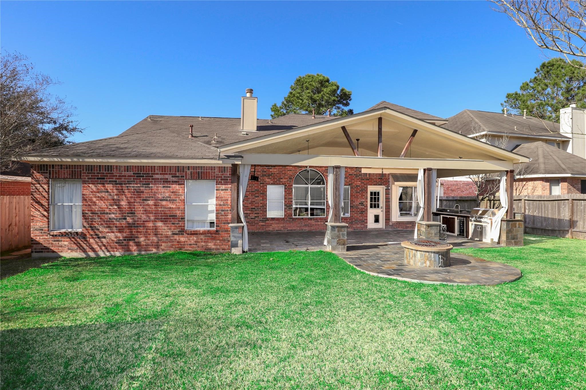 23207 Olive Ridge Court Katy, TX 77494 - Photo 3 of 45 a patio with a table and chairs under an umbrella