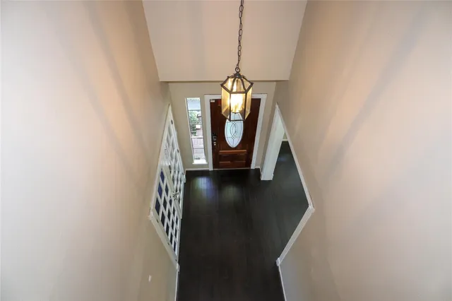 a view of a livingroom with wooden floor and staircase