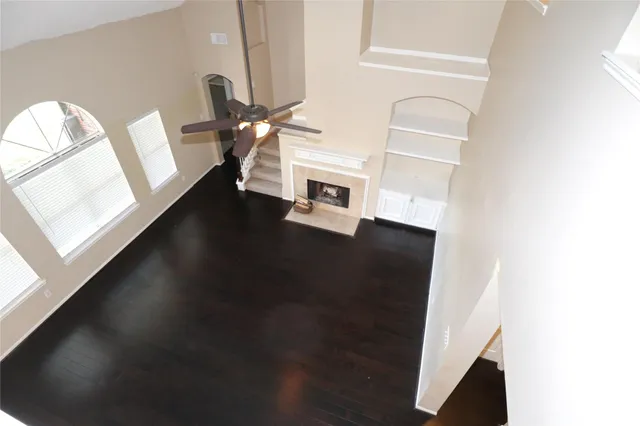 an empty room with a window and a fan