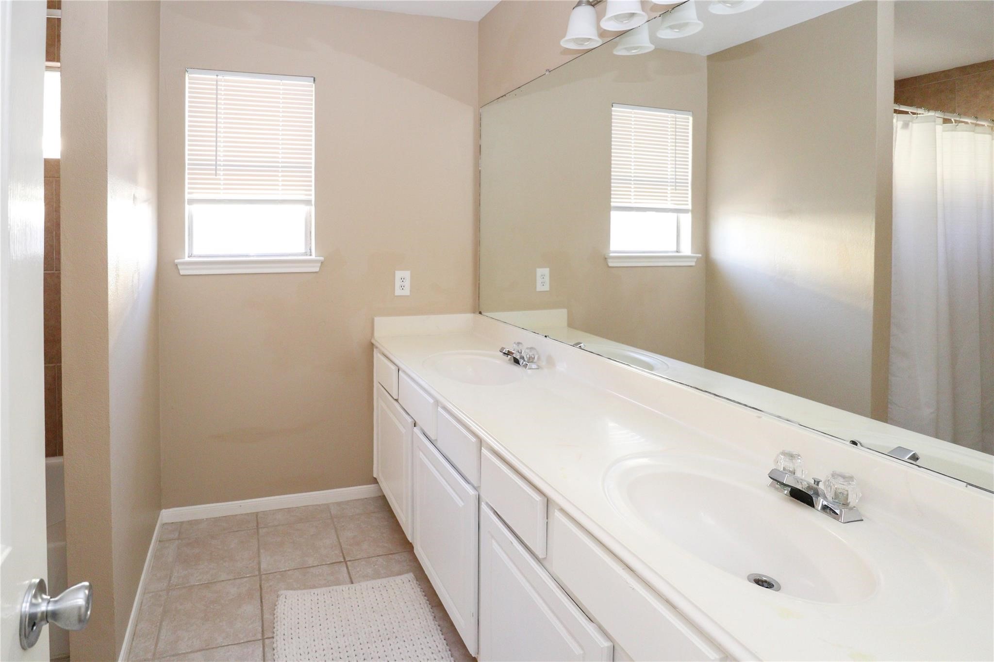 23207 Olive Ridge Court Katy, TX 77494 - Photo 41 of 45 a bathroom with a sink a vanity and a mirror