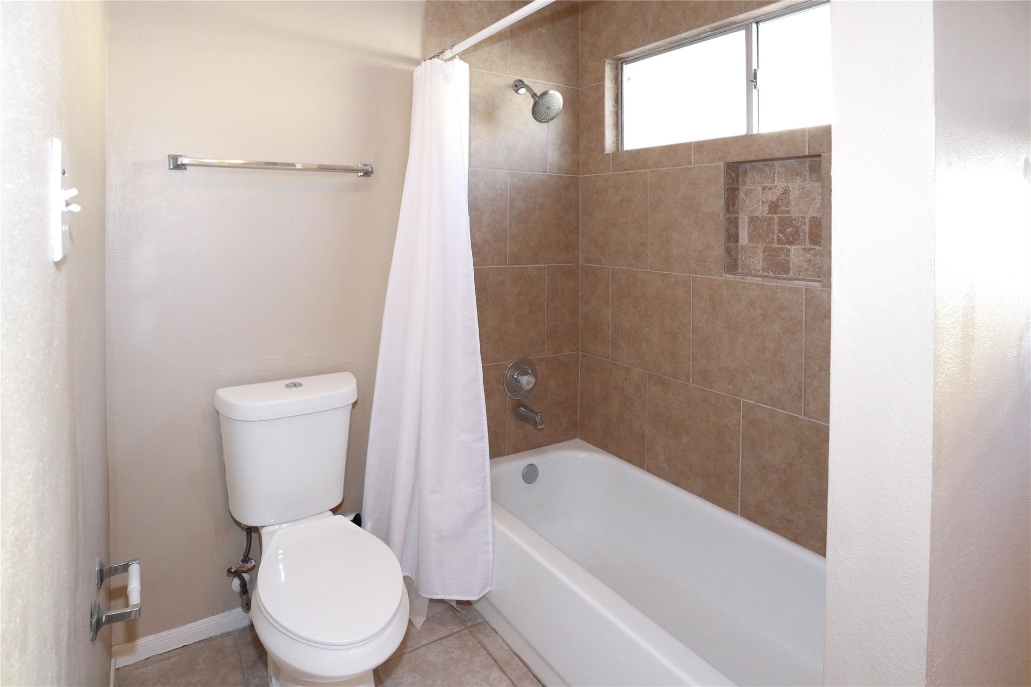 23207 Olive Ridge Court Katy, TX 77494 - Photo 42 of 45 a white toilet sitting next to a bath tub