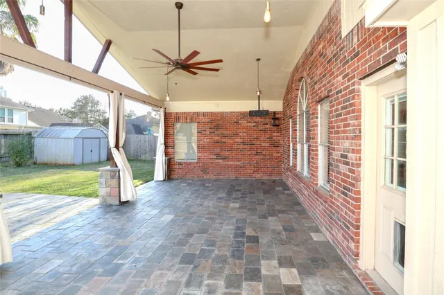 a view of a porch with a table and chairs