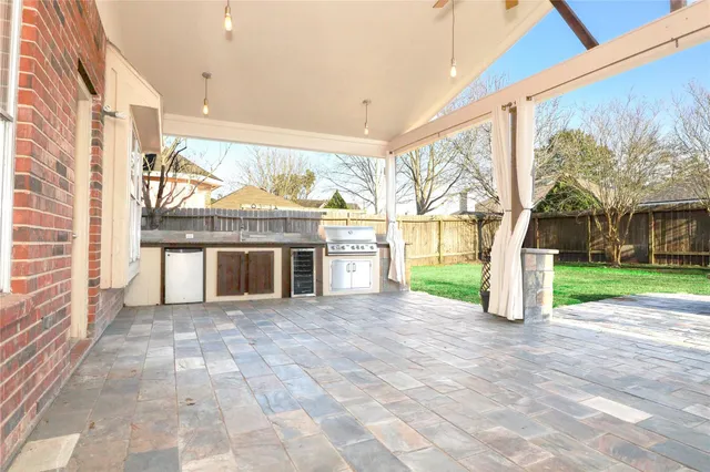 a view of a kitchen with stainless steel appliances granite countertop a stove and a sink